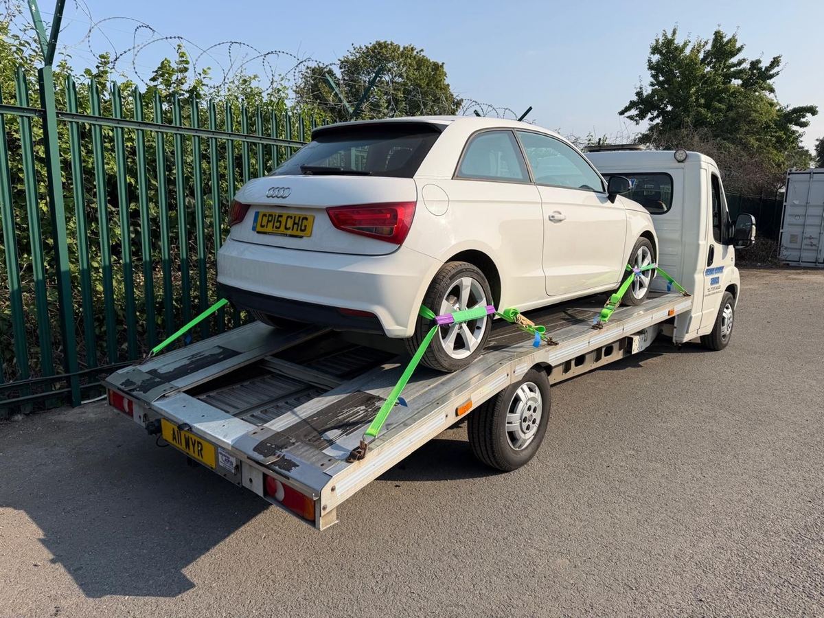 White Audi A1 strapped down on our light recovery truck