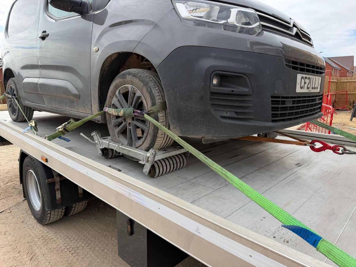 Van wheel secured to the flatbed with soft straps
